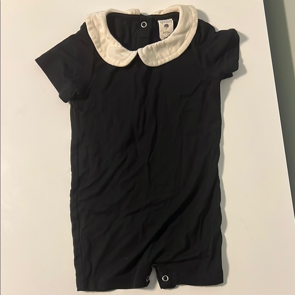 Kate Quinn black romper with white Peter Pan collar